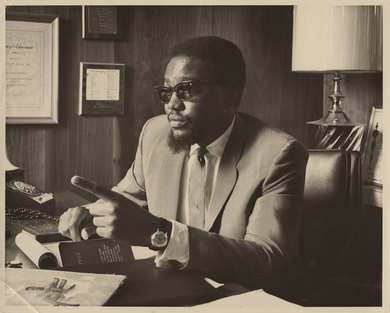 Al Bell at his desk in 1967, surrounded by awards and citations
